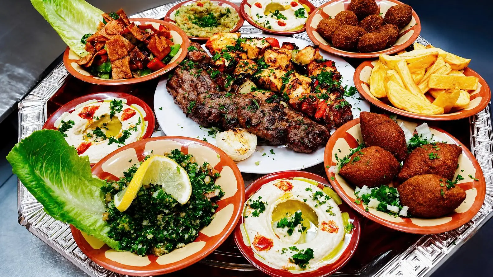 A large tray of Lebanese mezza and grilled meats